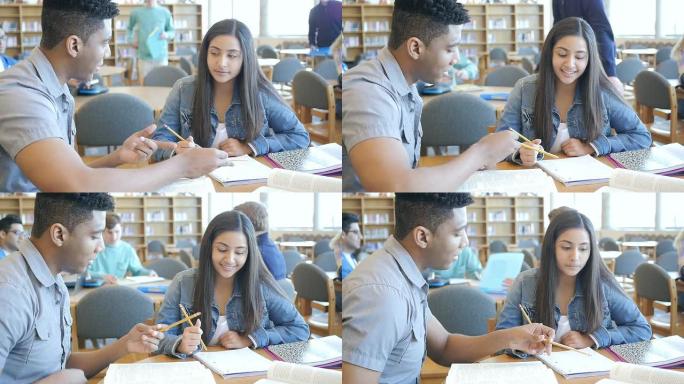 非裔美国高中生在图书馆辅导一年级印度女孩