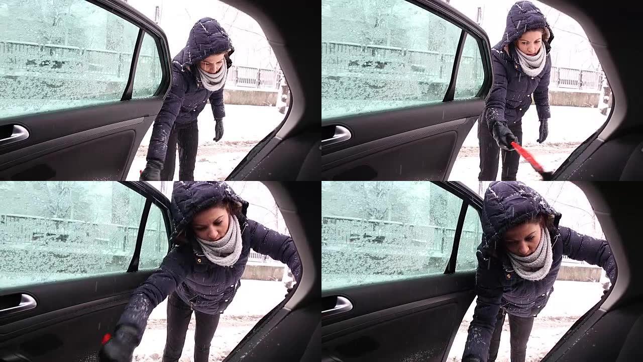 年轻女子清除汽车上的积雪。