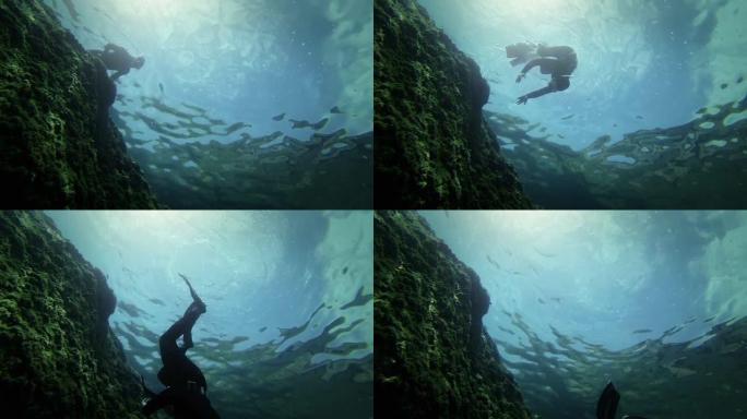 在深渊中下降的自由潜水员