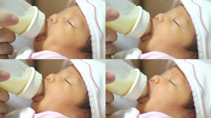 婴儿从奶瓶里吸奶小婴儿喝奶特写奶粉喂养特