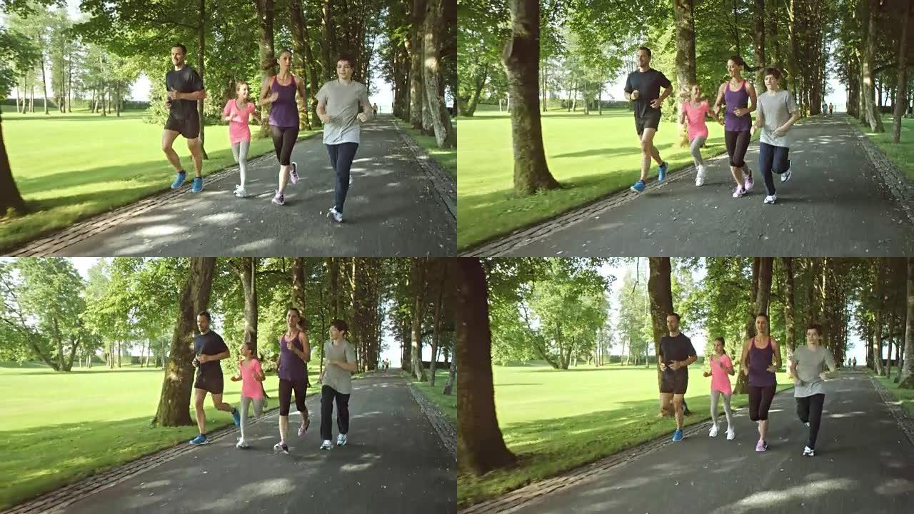 在阳光明媚的日子里，SLO MO TS一家人在公园里慢跑