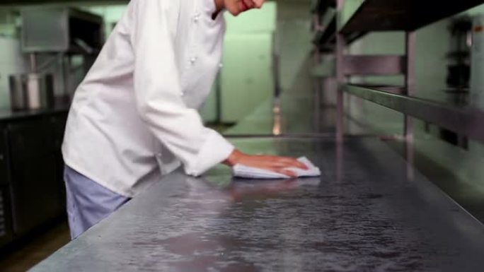 快乐的厨师在擦拭柜台