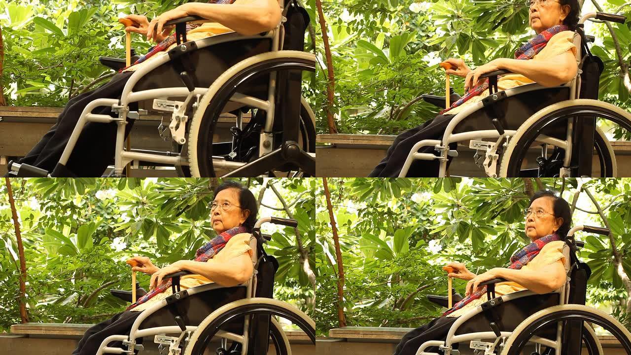 坐在轮椅上的亚洲成年妇女