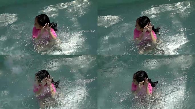 小女孩在游泳池玩水