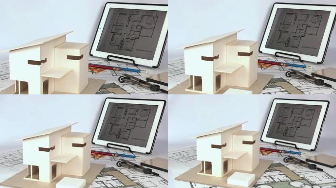 建筑师使用房屋模型和蓝图