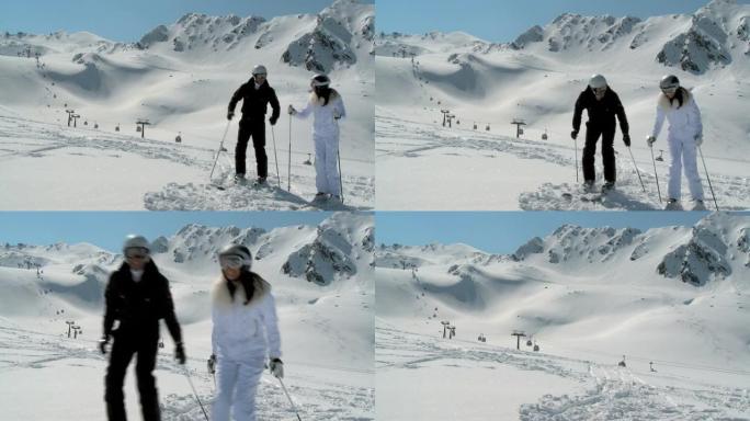 斜坡上的情侣开始滑雪，美丽的全景
