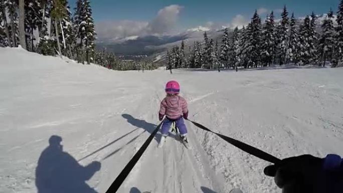 年轻女孩学习滑雪引导保护小女孩
