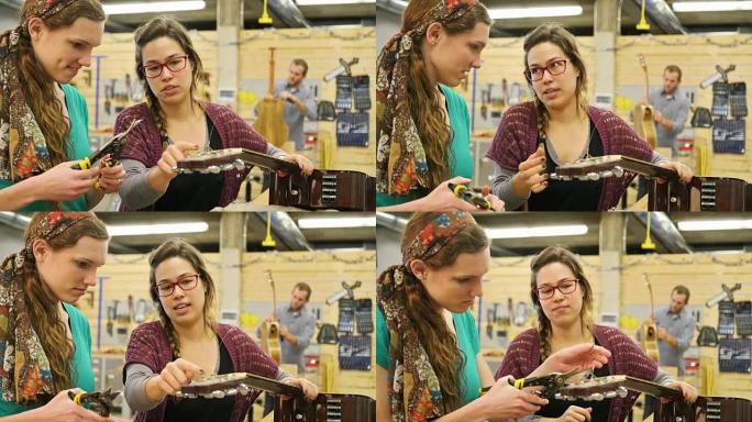 年轻女性音乐商店经理向学员展示如何重新弹奏原声吉他