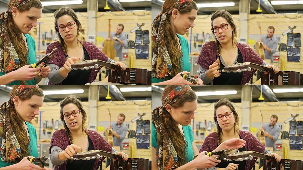 年轻女性音乐商店经理向学员展示如何重新弹奏原声吉他