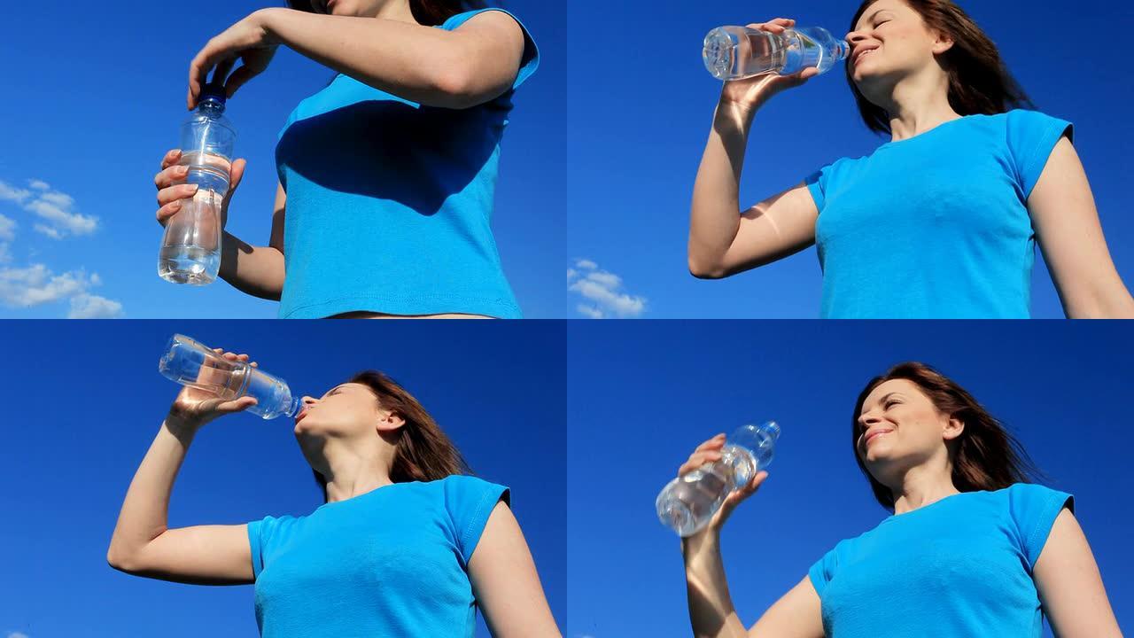 一个年轻的女人在喝瓶装的淡水。