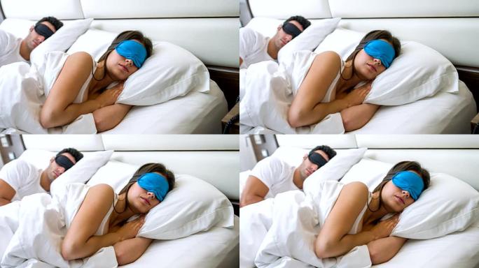 戴着眼罩睡觉的夫妇