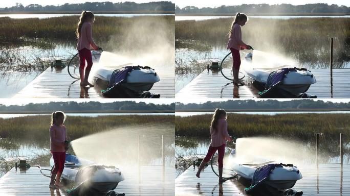 8岁女孩在码头上喷洒她的皮划艇