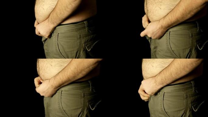 试图穿牛仔裤的超重男子