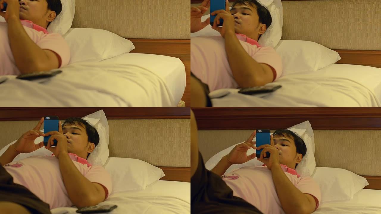侧视图: 男人睡觉和玩智能手机