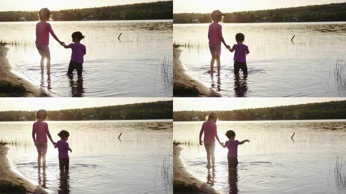 日落时在湖水中涉水的姐妹
