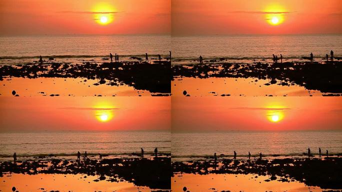 热带日落海滩上的延时人群