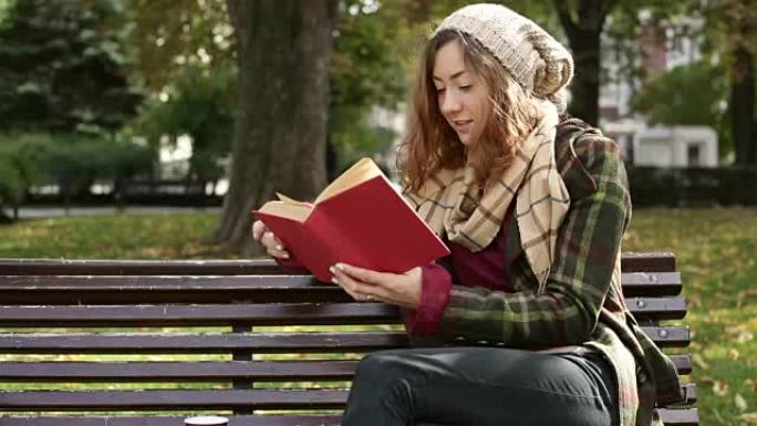 学生女生阅读课本坐在公园长椅上校园兴趣爱