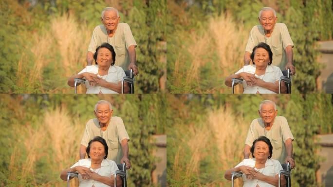 一位老人推着她残疾的妻子坐在轮椅上