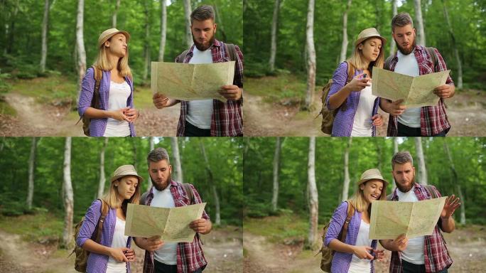 夫妇徒步旅行者在森林里用徒步旅行地图制定计划