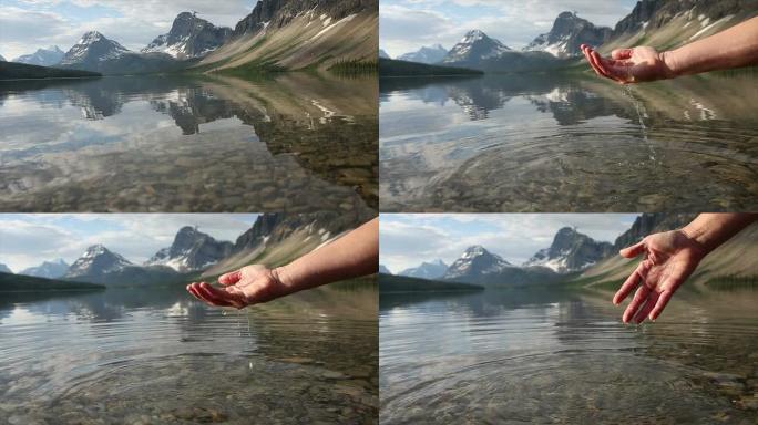 人的手在山湖里舀水