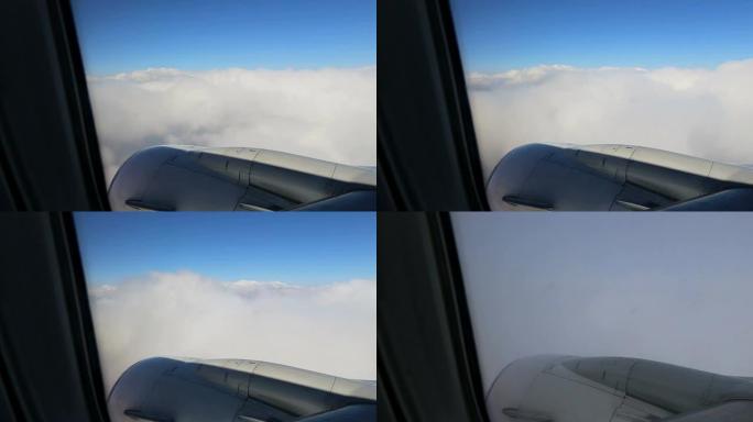 经历湍流的平面云海高空机翼机舱窗外