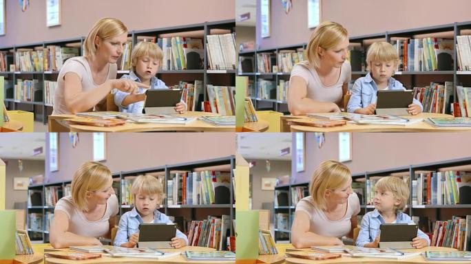 DS妈妈监督儿子在公共图书馆使用平板电脑
