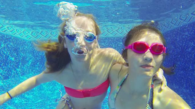 十几岁的女孩在水下吹泡泡的特写