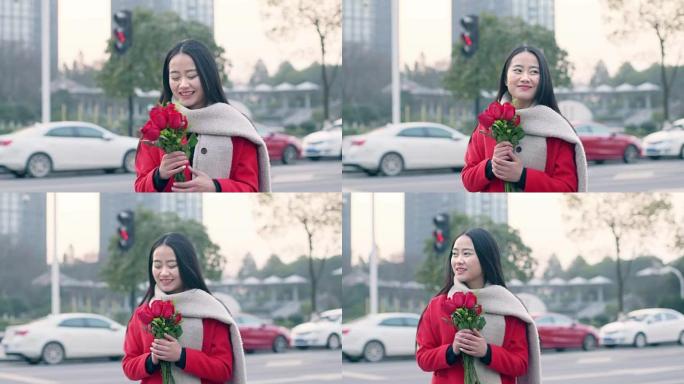 美丽的亚洲女孩手捧一束红花