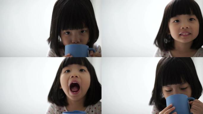 亚洲女童享受她的一杯牛奶