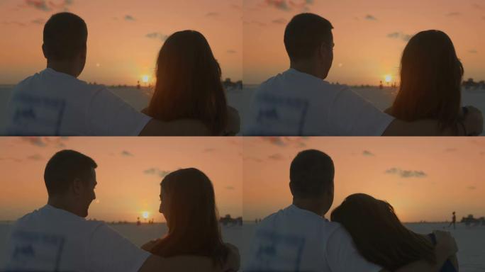 慢镜头爱情年轻情侣在日落海滩接吻