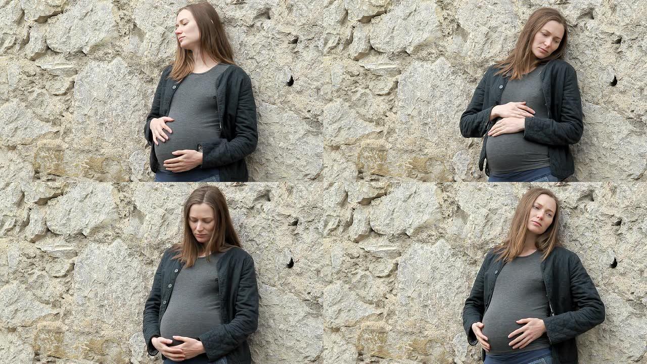 站在城墙附近的孕妇