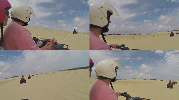 一对幸福的夫妇在沙漠中驾驶四轮自行车