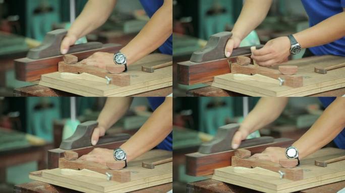 木匠用手刨平木板的手