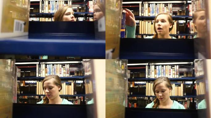 漂亮的女性高加索家庭高中学生在公共图书馆寻找书籍