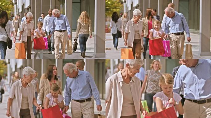 DS的祖父母和孙女手里拿着购物袋