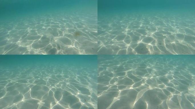 SILANCE Vs.NOICE水下拍摄清澈的蓝色水和白色的沙子。