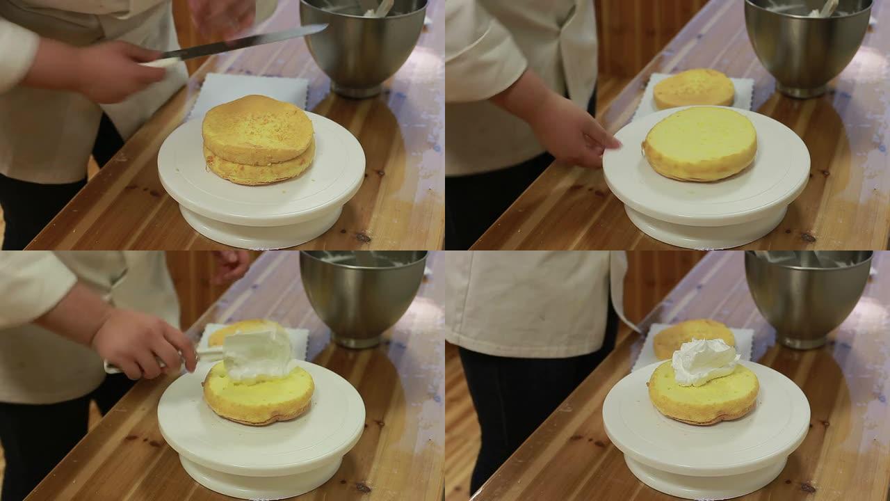 厨师将蛋糕切成两半，然后涂上奶油