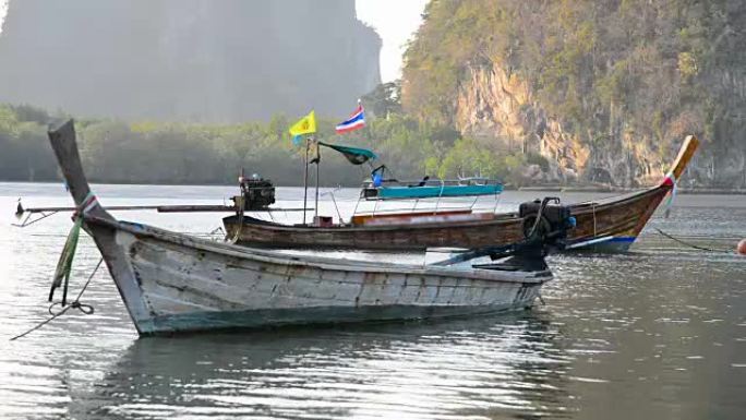 泰国南部热带海域美丽的日落，长尾船