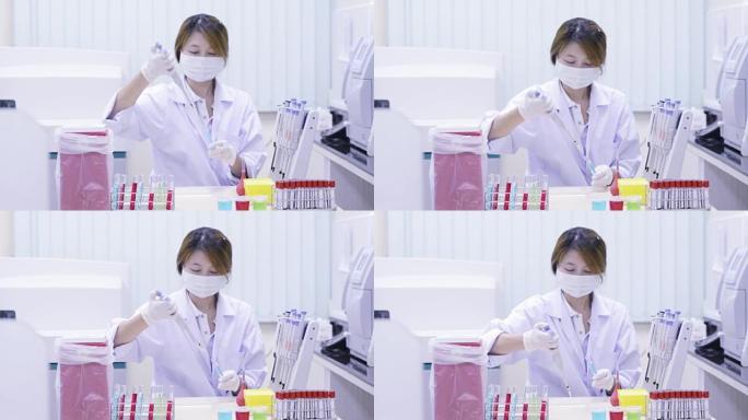 女孩在实验室移液管里装满样品。