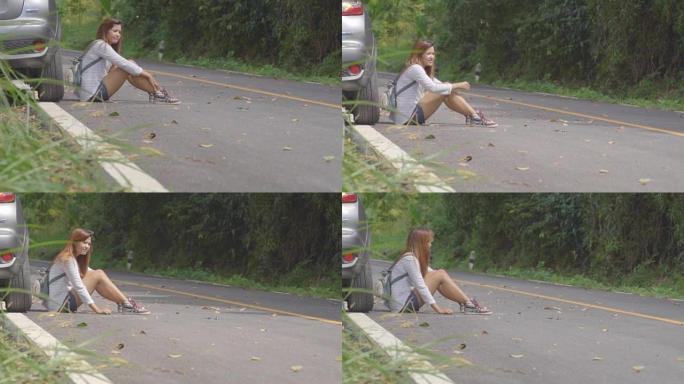车祸后坐在路上的悲伤漂亮女孩