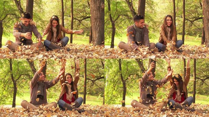 情侣在公园里扔秋叶