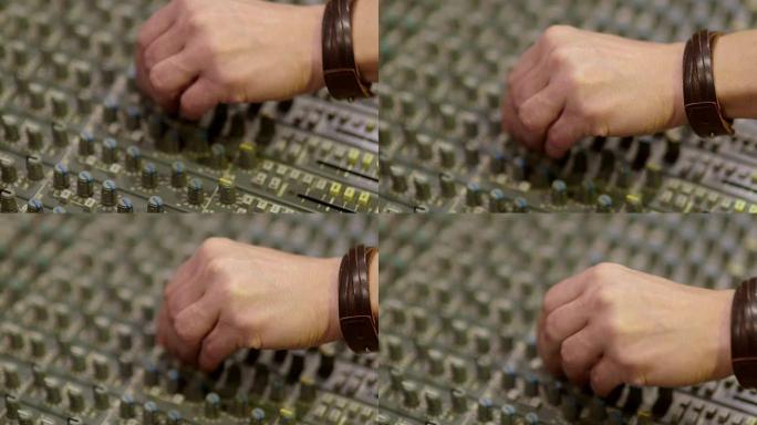 特写男人的手操作混音器