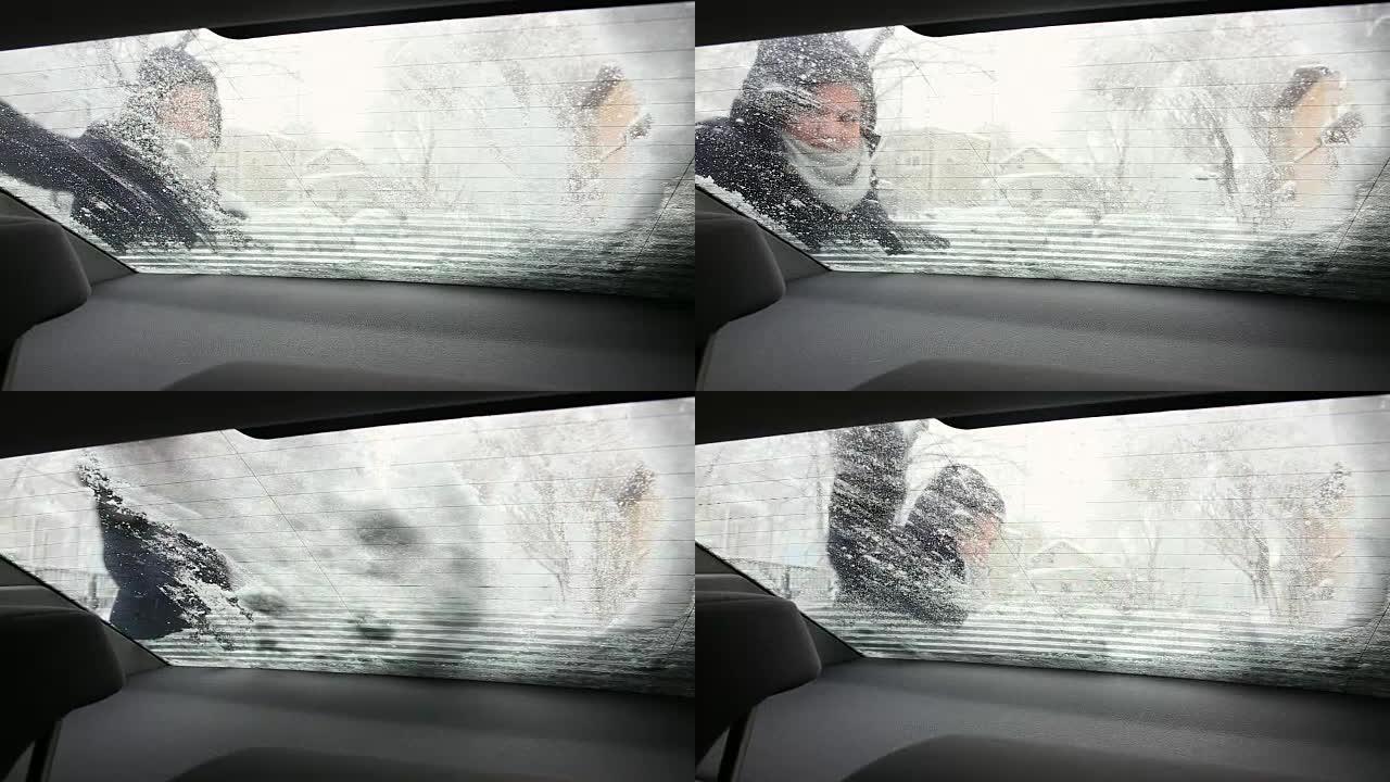 年轻女子清理汽车后窗的积雪。