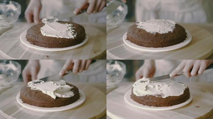 厨师在模型蛋糕上涂抹奶油
