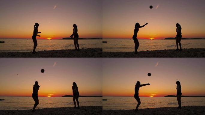 高清：美丽的女人在日落的海滩上打排球