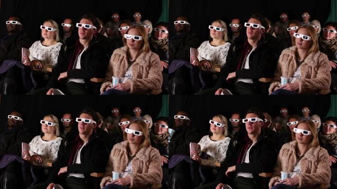 人们戴着3D眼镜在电影院看电影