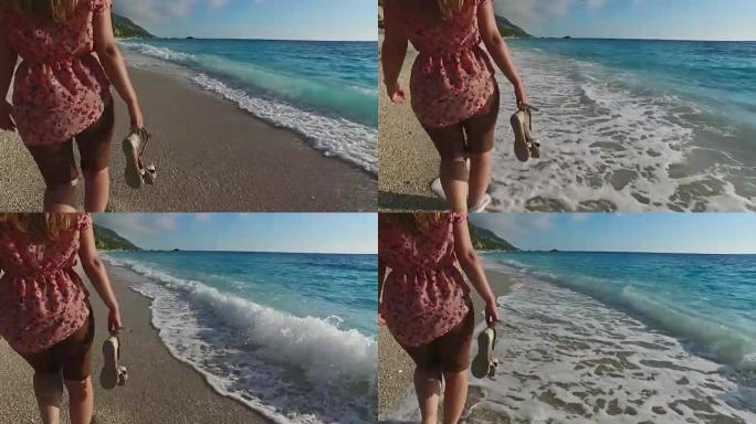 女孩赤脚走在沙滩上