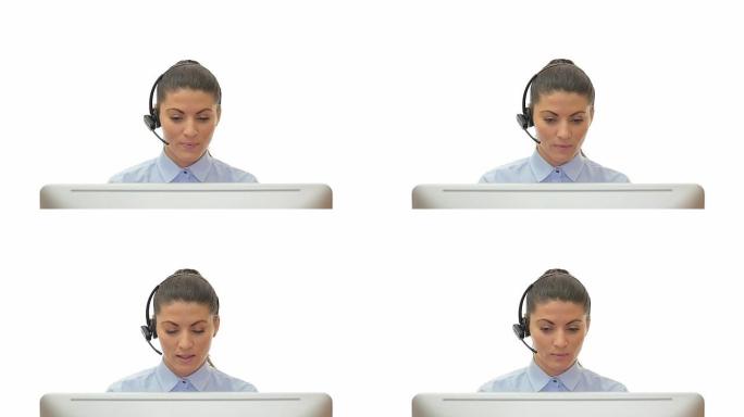 美丽的年轻女子客服在电脑前通过白色背景的耳机交谈。