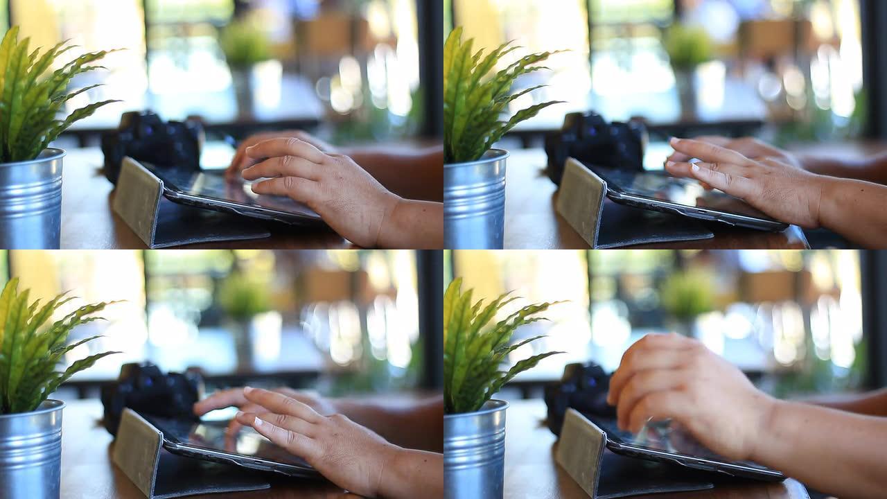 在咖啡厅使用数字平板电脑的人