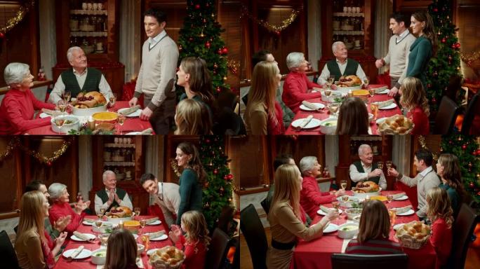 夫妇与家人在圣诞节餐桌上分享喜讯